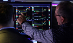 FILE PHOTO: Traders work on the floor of the NYSE in New York